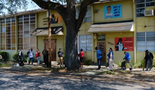 A building with people milling about out front