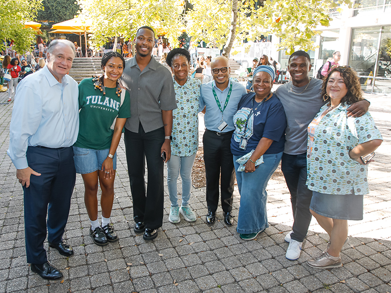 A smiling group including Tulane President Mike Fitts, Carolyn Barber-Pierre, and Anneliese Singh pose for a photo at commUNITY 2026.