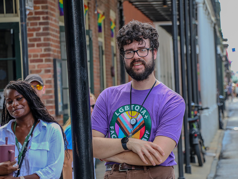 A Tulanian participates in the Pride walking tour through the French Quarter.