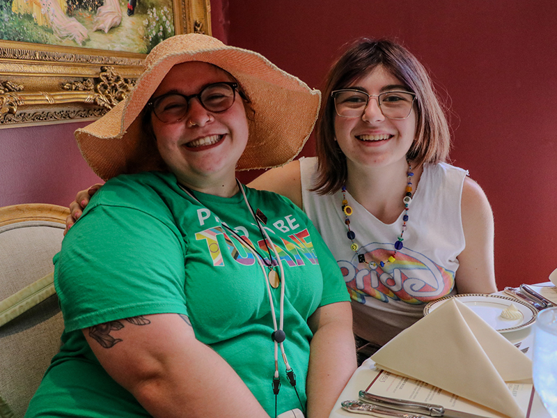 Two Tulanians smile at the camera during a lunch on Pride day 2025.