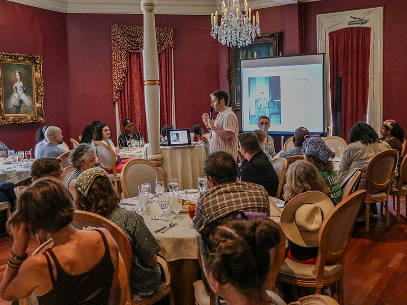 Tulanians listen to a Pride speech at a restaurant in the French Quarter in 2025