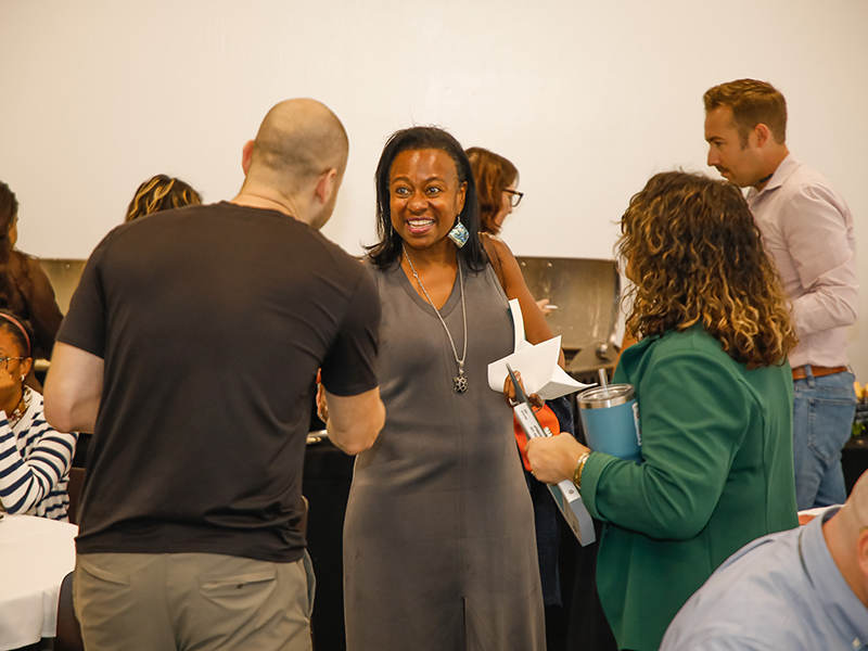 Tulane faculty smile and shake hands after a Booked! workshop.