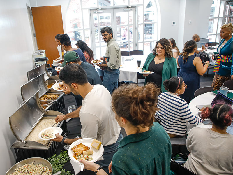Tulanians gather around a buffet table after a Booked! workshop.