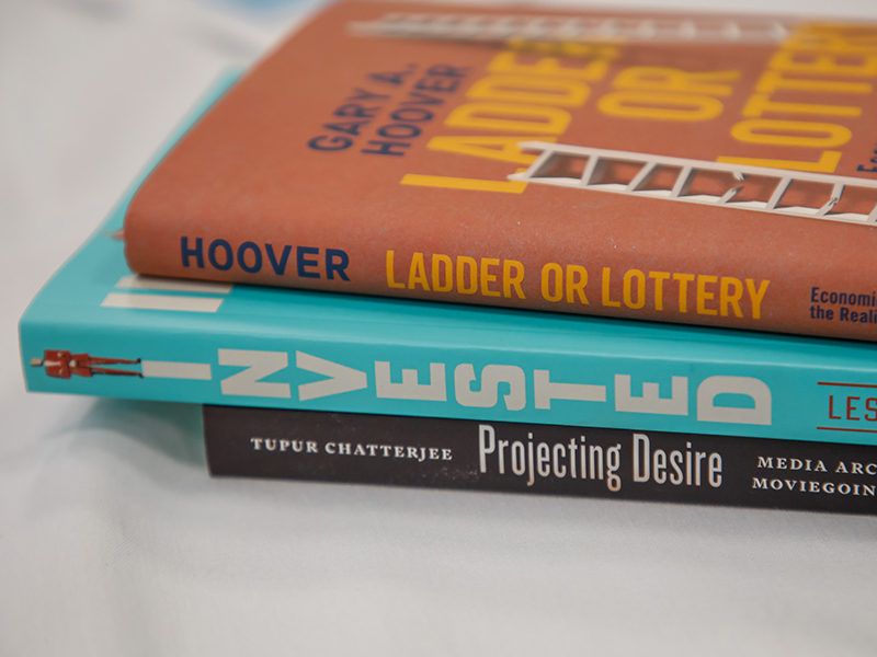 A stack of three books on a table at the Booked! workshop.