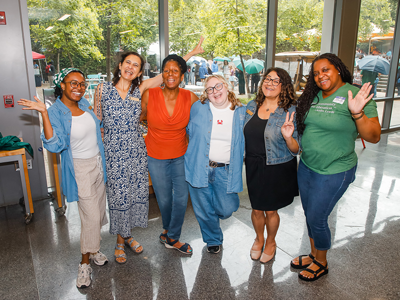 Tulane AEO staffers smile at the camera during Juneteenth on Tulane's Uptown campus.