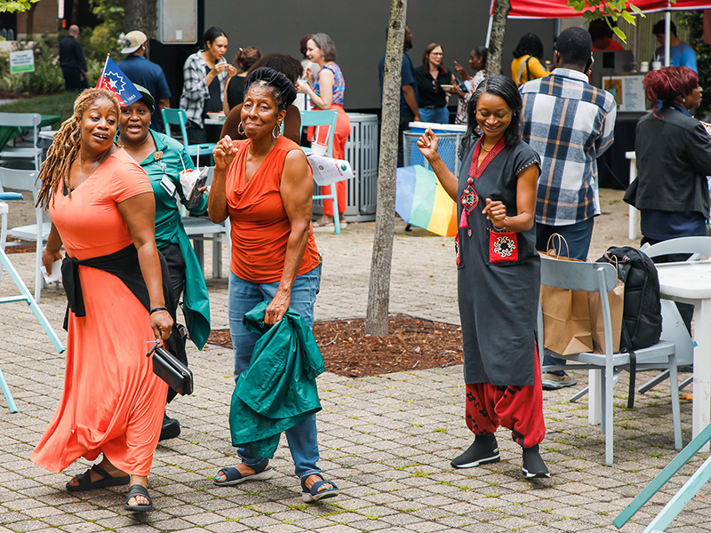 Carolyn Barber-Pierre and Tulane friends dance together during Juneteenth on Tulane's Uptown campus.