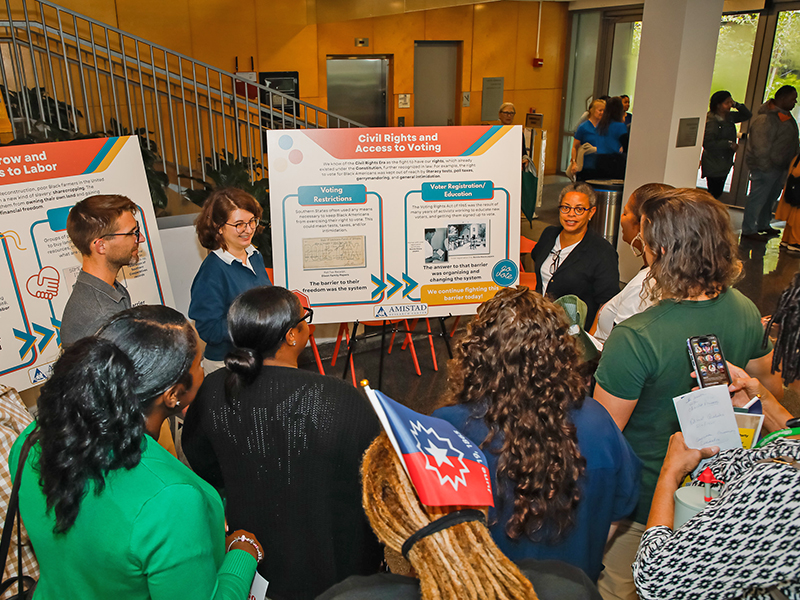 A group of people listen to a presentation during Juneteenth on Tulane's Uptown campus.