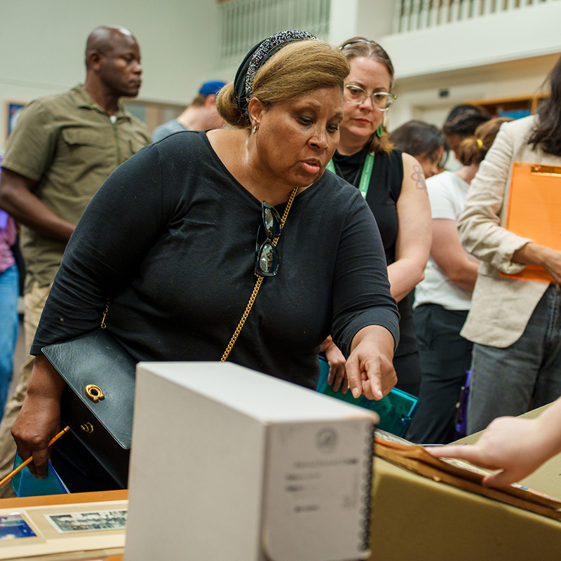 A group stands around an exhibit at the Amistad Research Center.
